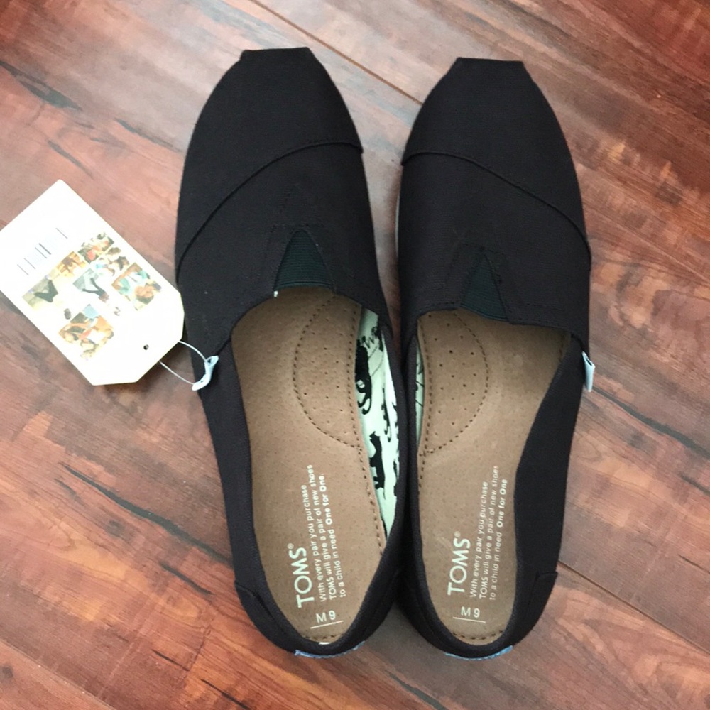 Never been worn/used classic black canvas Toms.
